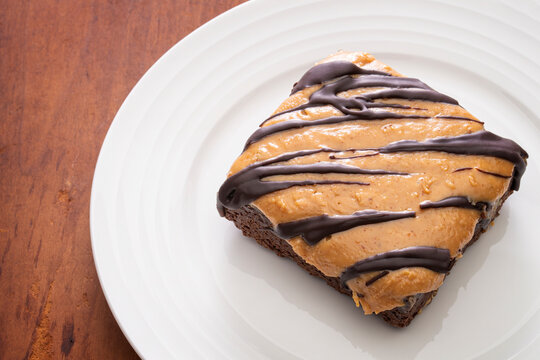 Gluten free chocolate brownie with peanut buter and dark chocolate drizzle on top