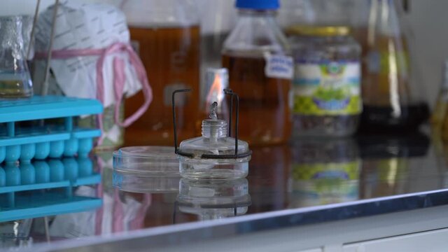 Burner glass on a table in a laboratory. Laboratory equipment. Burner tube for scientists. Fire in Research laboratory. Bacteriological culture. Medicine and microbiology concept.