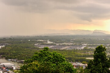 Obraz premium Aerial View of Fishing Village at Pak Nam Chumphon from Matsee Mountain During Sunset