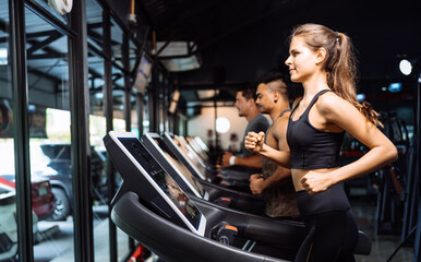 Fototapeta na wymiar Sporty Group Running Cardio on Treadmills Exercise Burning Calorie in Fitness Gym Fit Body Healthy Lifestyle Athlete Muscle Building Strong Endurance in Health Club.