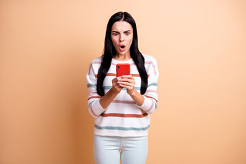 Photo of young shocked amazed surprised girl see dislike in smartphone wear white pants isolated on...