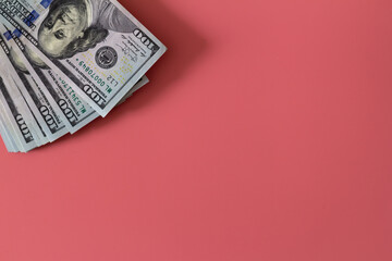 Flat closeup of dollars on pink background. Investment profit income. Success concept. Finance investment concept. Dollar sign. Hundred dollar bill.