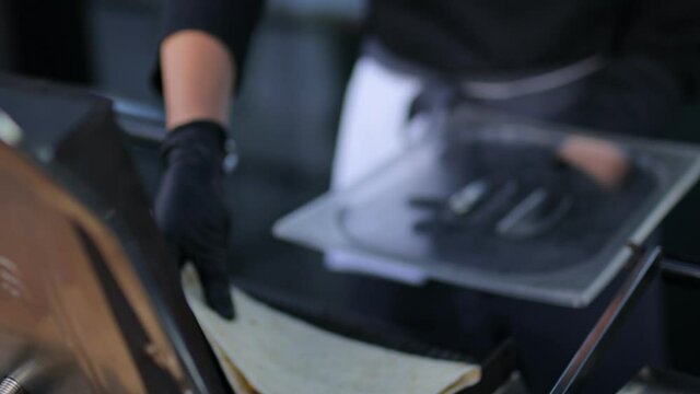 The chef prepares tacos. Making fresh tacos.a chef in black gloves and a black jacket prepares tacos. the process of preparing a traditional Mexican food taco.