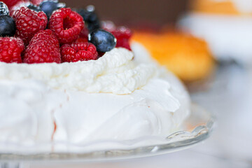 Pavlova cake with meringue, cream and red berries