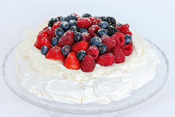 Pavlova cake with meringue, cream and red berries