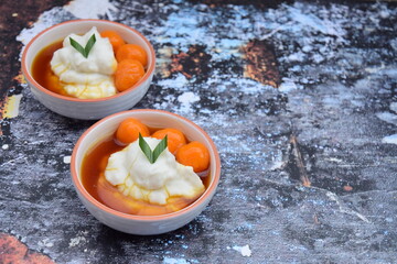 Bubur Sumsum Biji Salak, Indonesian rice flour porridge with sweet potato glutinous rice balls, served with palm sugar sauce, garnish with pandan leaf. Popular food during Ramadan