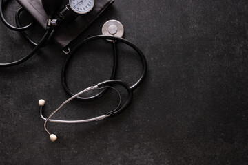 tonometer, pressure measuring device on gray dark table, empty space for text