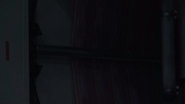 Printing house. Printing on film. Anilox. Flexo printing. The film slides along the shaft. Checking the print.