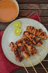 Chicken Satay or Sate Ayam - Indonesian food. Skewered and grilled meat, served with a peanut sauce. 