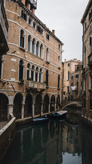 Fototapeta na wymiar Ancient building along the canal. Venice Italy