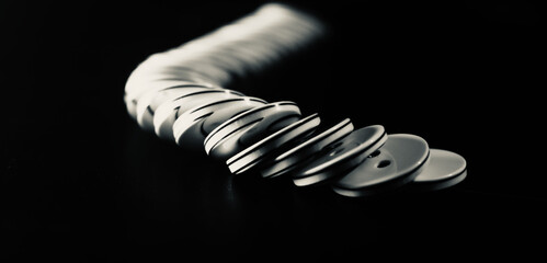 stack of plastic buttons black background