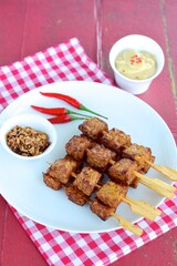 Tempeh Skewers served with spicy peanut sauce and fried onion