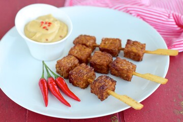 Tempeh Skewers served with spicy peanut sauce and fried onion