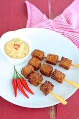 Tempeh Skewers served with spicy peanut sauce and fried onion