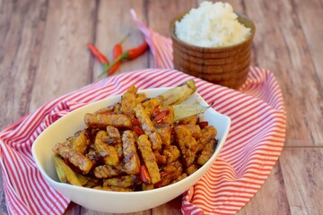 Tempe sweet soy sauce with steamed white rice on wooden background