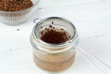 Making natural hair setting lotion for perfect hair. Boiled flax seeds filtered into a jar. Organic and  healthy  stylish hair lotion.