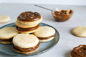 Alfahores cookies with condensed milk on a gray plate. Traditional homemade biscuits. Homemade food concept. Horizontal orientation.