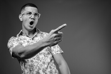 Young multi-ethnic Asian tourist man against brown background