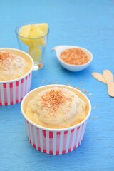 Coconut pineapple yogurt ice cream on blue background