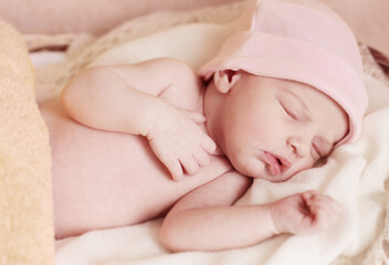sleeping baby in pink hat close up