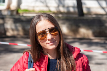 A young woman is standing in front of a restricted area