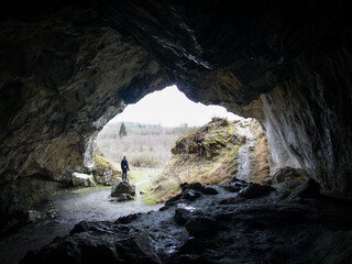 hiker looking at view inside the cave