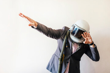 Businessman with astronaut helmet euphoric celebrating