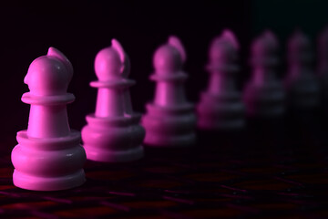 Pink plastic chess pieces in a row 