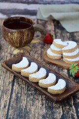 Putri Salju or crescent-shaped cookies coated with powdered sugar. Traditional Indonesian cookies to celebrate Eid al Fitr