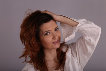 Fototapeta premium a beautiful woman straightening her hair with her hands