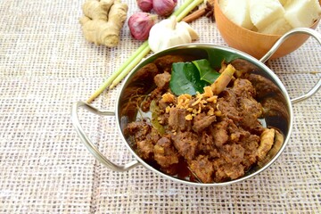 Beef Rendang. The popular Indonesian food, spicy beef stew. Served with Lontong or steamed rice cake
