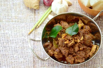 Beef Rendang. The popular Indonesian food, spicy beef stew. Served with Lontong or steamed rice cake