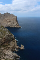 Fototapeta na wymiar Amazing natural landscape with rocks, calm sea and cloudy skies. Majorca, Balearic Islands, Spain