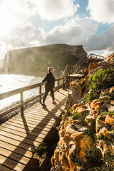 Mixed race woman walking into the sun along the coast in Robberg Nature Reserve, South Africa