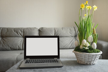 Easter composition and laptop for online translation church service in quarantine time. Spring interior for online DIY workshop.