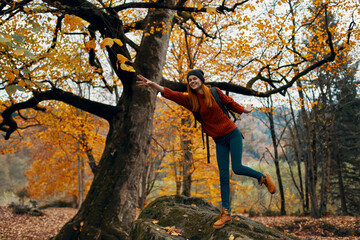 happy traveler in park near big tree landscape nature yellow leaves model emotions