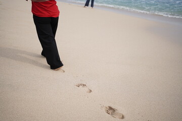 Footprints of women on white sandy beaches