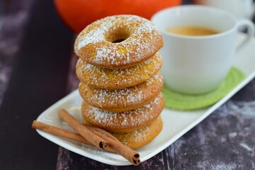 Homemade cinnamon pumpkin donuts with a cup of coffee