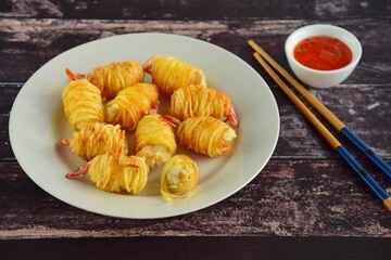Deep fried prawns wrapped in potato strings served with chili sauce