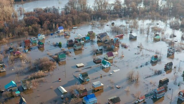 The Concept of disaster prediction. The rays of the setting sun illuminate the flooded village. Drone footage. High quality. 4k footage.