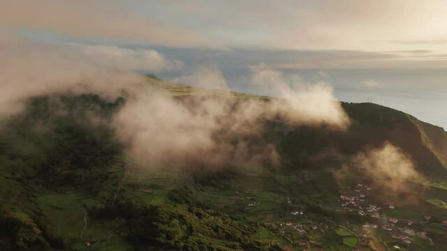 Panoramic shot of evergreen island of Flores. Small village in Poco Ribeira do Ferreiro valley, Alagoinha, Flores Island, Azores, Portugal, Europe. clouds mobing on sky, 4k footage