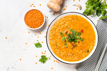 Lentil soup with vegetables at white stone table. - obrazy, fototapety, plakaty