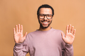 Portrait of African American male holding hand in stop sign, warning and preventing you from...