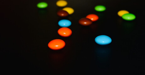 colourful candy on black surface 