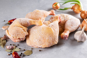 Frozen meat. Frozen chicken legs on a light background. Raw chicken meat. - obrazy, fototapety, plakaty