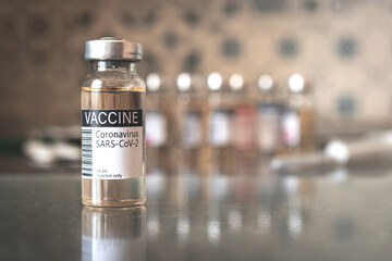 COVID-19 vaccine development and manufacture process, medical and hospital background, vaccination concept with label close-up