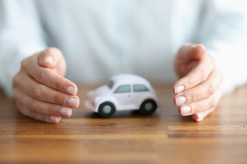 There is white car inside woman hands