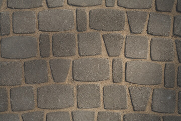 Paving stone. Brick pavement texture. Gray bricks.