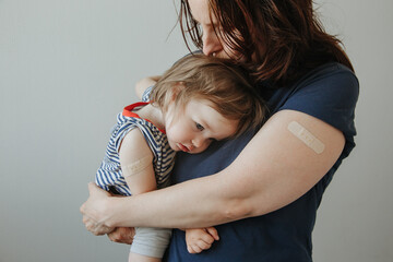 mother and daughter, a child after vaccination. A child with poor health and a high temperature.