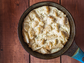 Fried cauliflower drenched in eggs and milk in a round soy pan